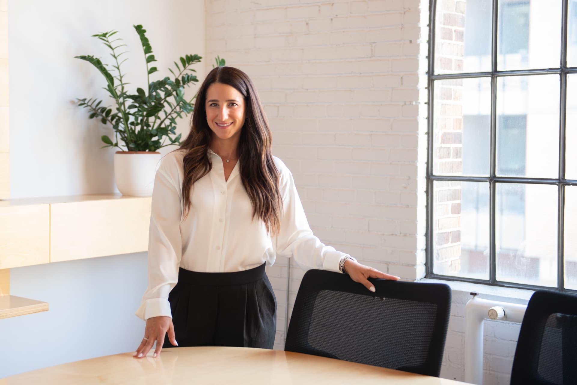 Jessica standing in a bright office
